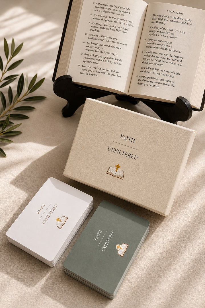 Faith Unfiltered card game box, cards, and open Bible styled in warm sunlight